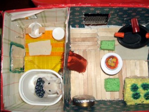 An ariel view of the bathroom & kitchen. A cutain seperates the rooms.