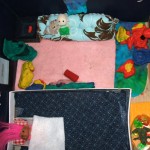 An aerial view of the multi-purpose room which features a hand-sewn couch, aquarium, sleeping area & games!
