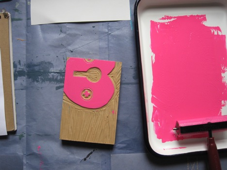 Squeeze out a pinkie sized amount of ink and get rolling, up and down and back and forth until the ink is smooth and even. I find the enameled butcher's tray to be simple to use and quick clean.