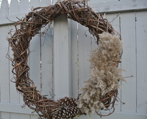 how to make a simple fall wreath out of twigs, vines and pine cones